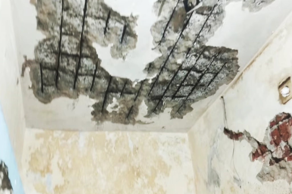 Overhead water tank leakage causing ceiling dampness and plaster damage