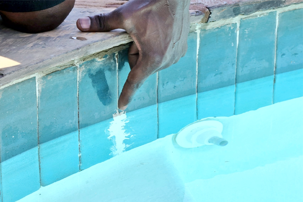 Swimming pool water leakage detected by drop in water level due to cracks or tile gaps
